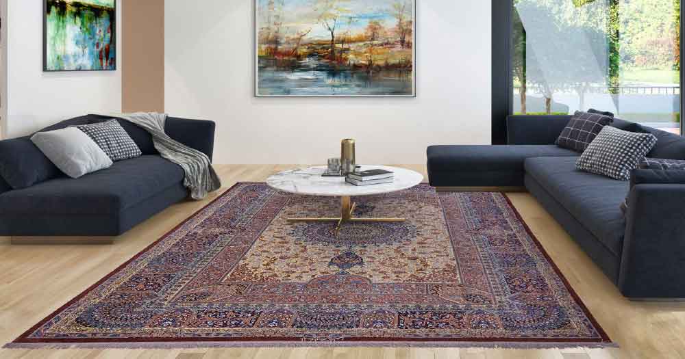 Ein bunter Teppich im Wohnzimmer zwischen Sofas und unter einem Tisch aus der Silk Collection